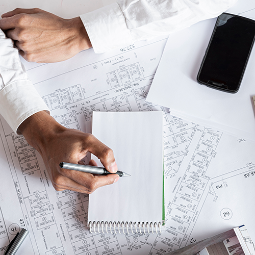 person planning out a drawing